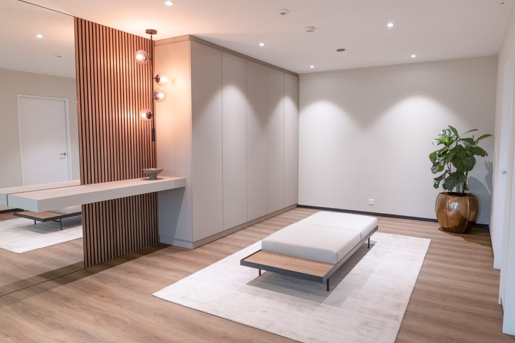 Minimalist hallway with wooden panel wall and custom built-in storage