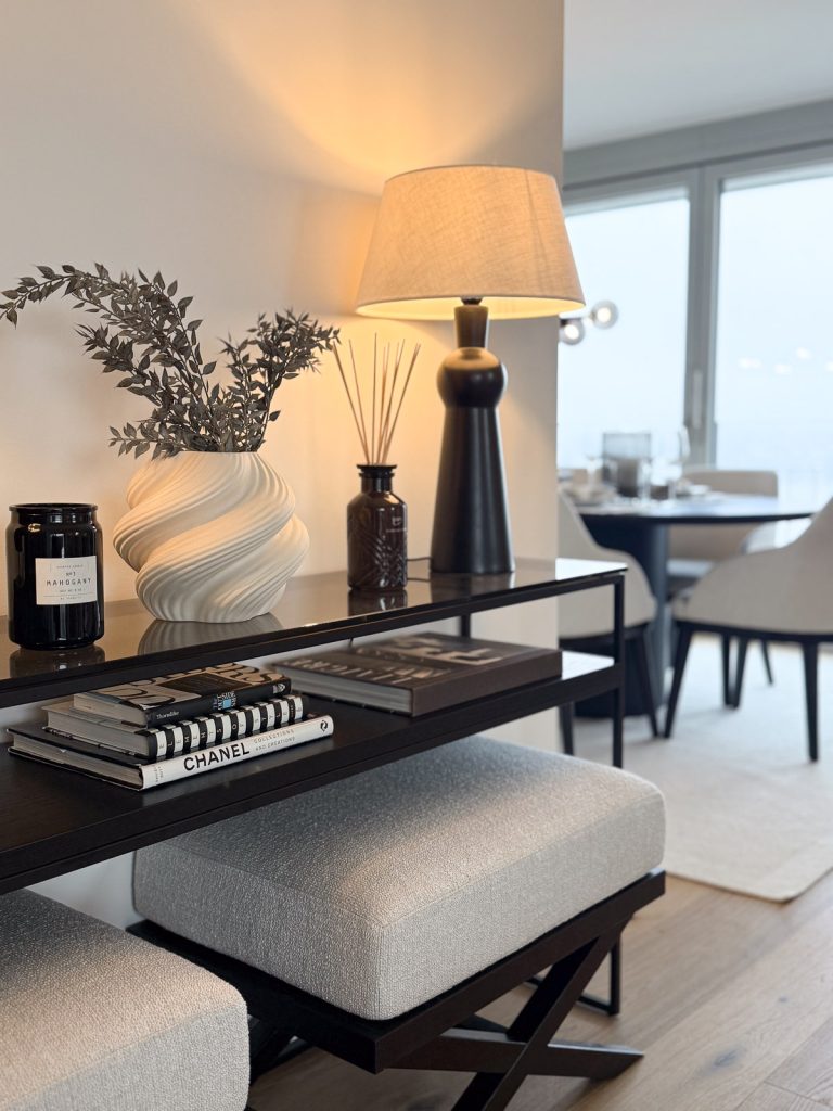Styled console table with decorative objects and table lamp